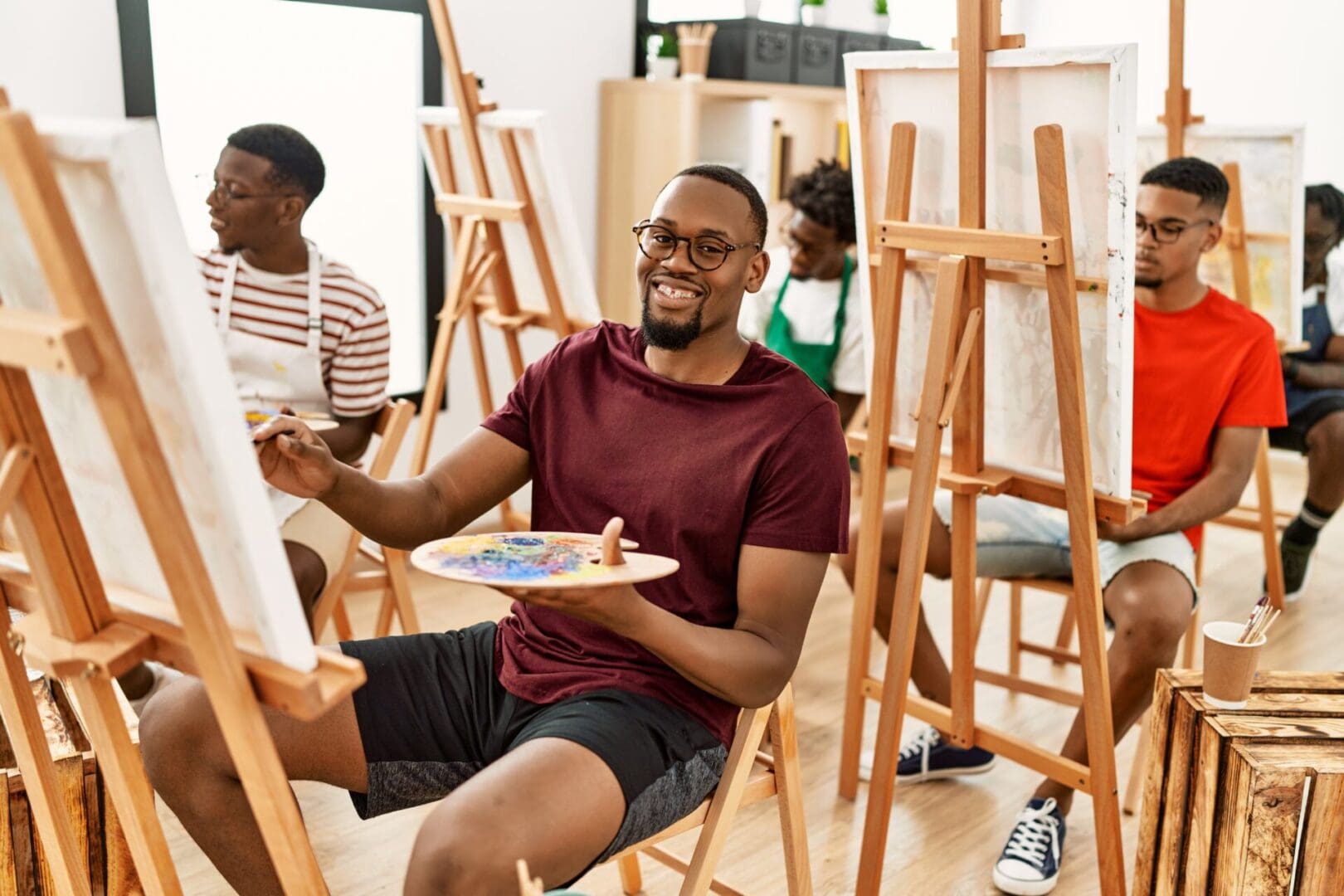 Group of young african american artist man smiling happy drawing at art studio.